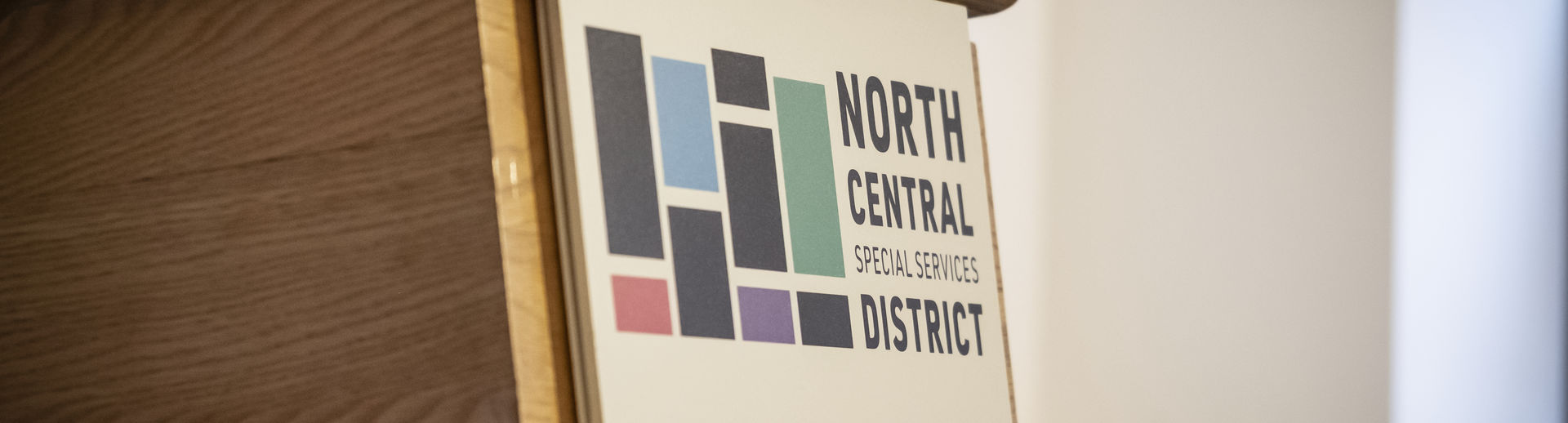 The North Central Special Services District signage on the front of a podium.