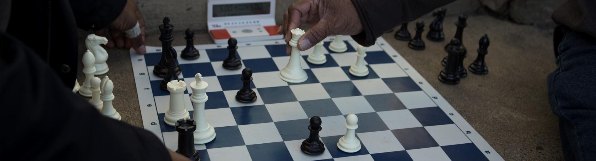 closeup of people playing chess