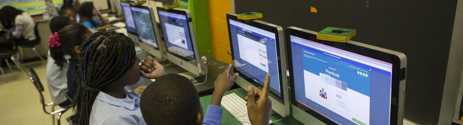 teenage students working together on computers
